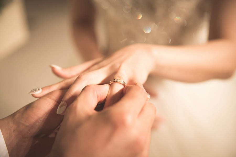 Groom placing the wedding ring on the brides finger